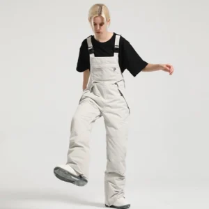 Light gray women's bib snow pants with adjustable buckle straps and relaxed snowwear silhouette
