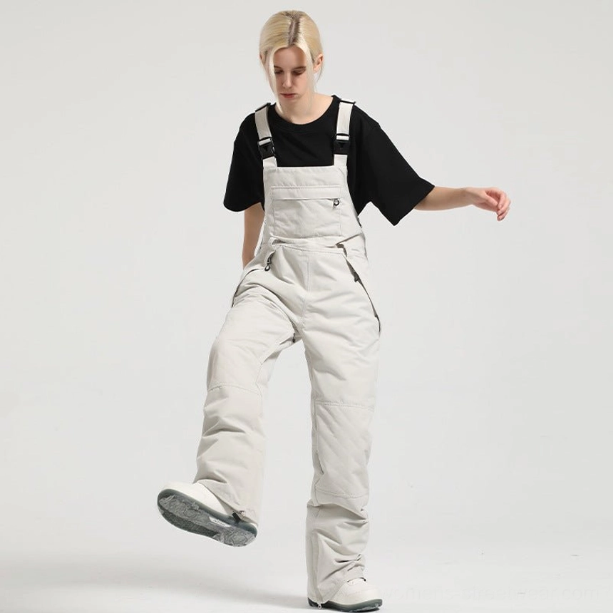 Light gray women's bib snow pants with adjustable buckle straps and relaxed snowwear silhouette