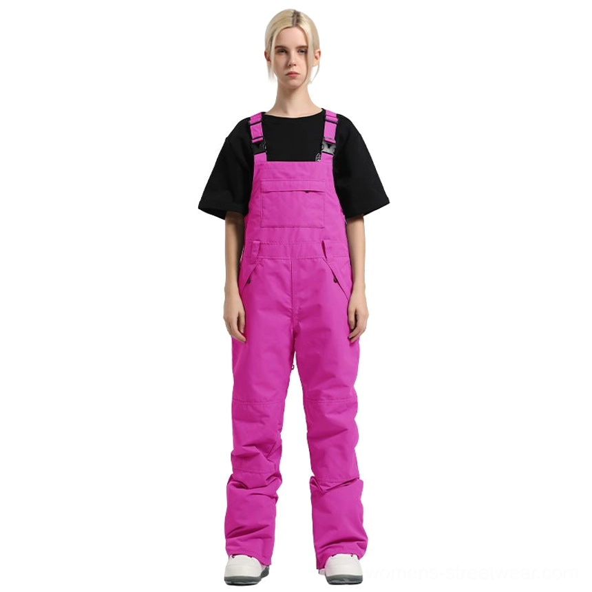 Magenta women's colorblock bib snow pants with adjustable shoulder straps and bold Korean streetwear-inspired styling