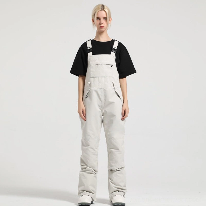 Off-white women's bib snow pants with front chest pocket, clean minimalist design, and winter streetwear fit