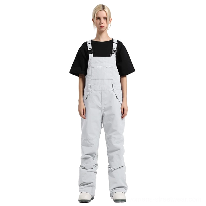 White women's colorblock bib snow pants with clean minimalist color, chest pocket, and adjustable utility straps