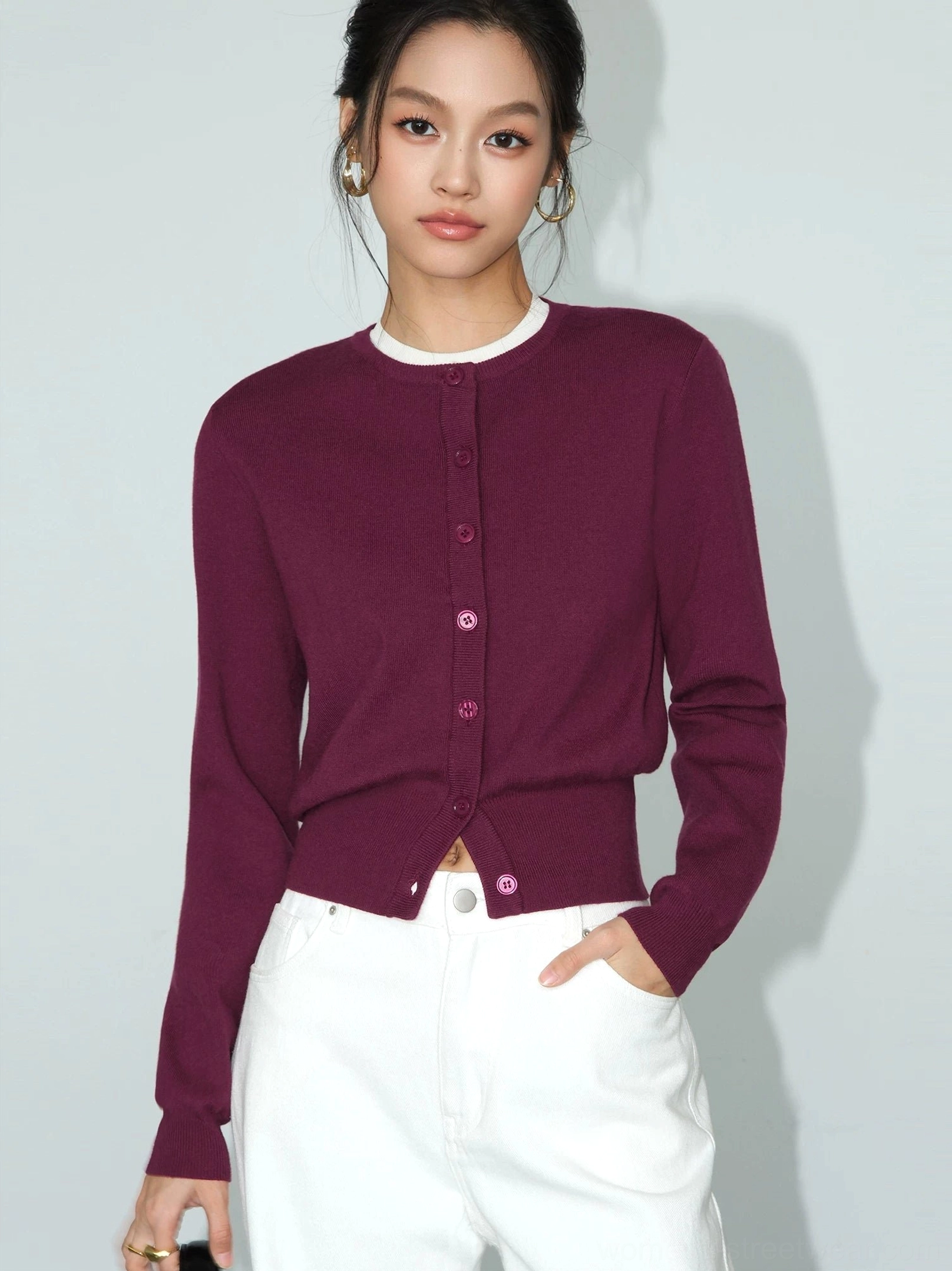 Berry red cropped crew neck button front knit cardigan for women in a front three-quarter studio view