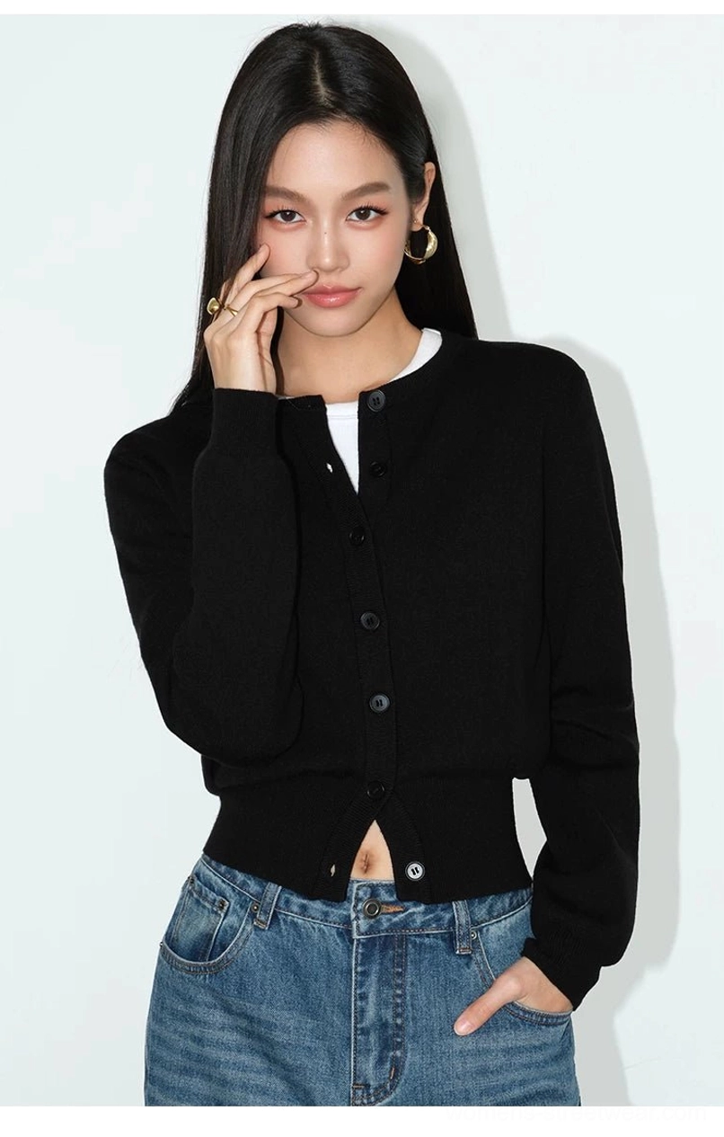 Black women's cropped button front knit cardigan with crew neck styled with casual blue denim
