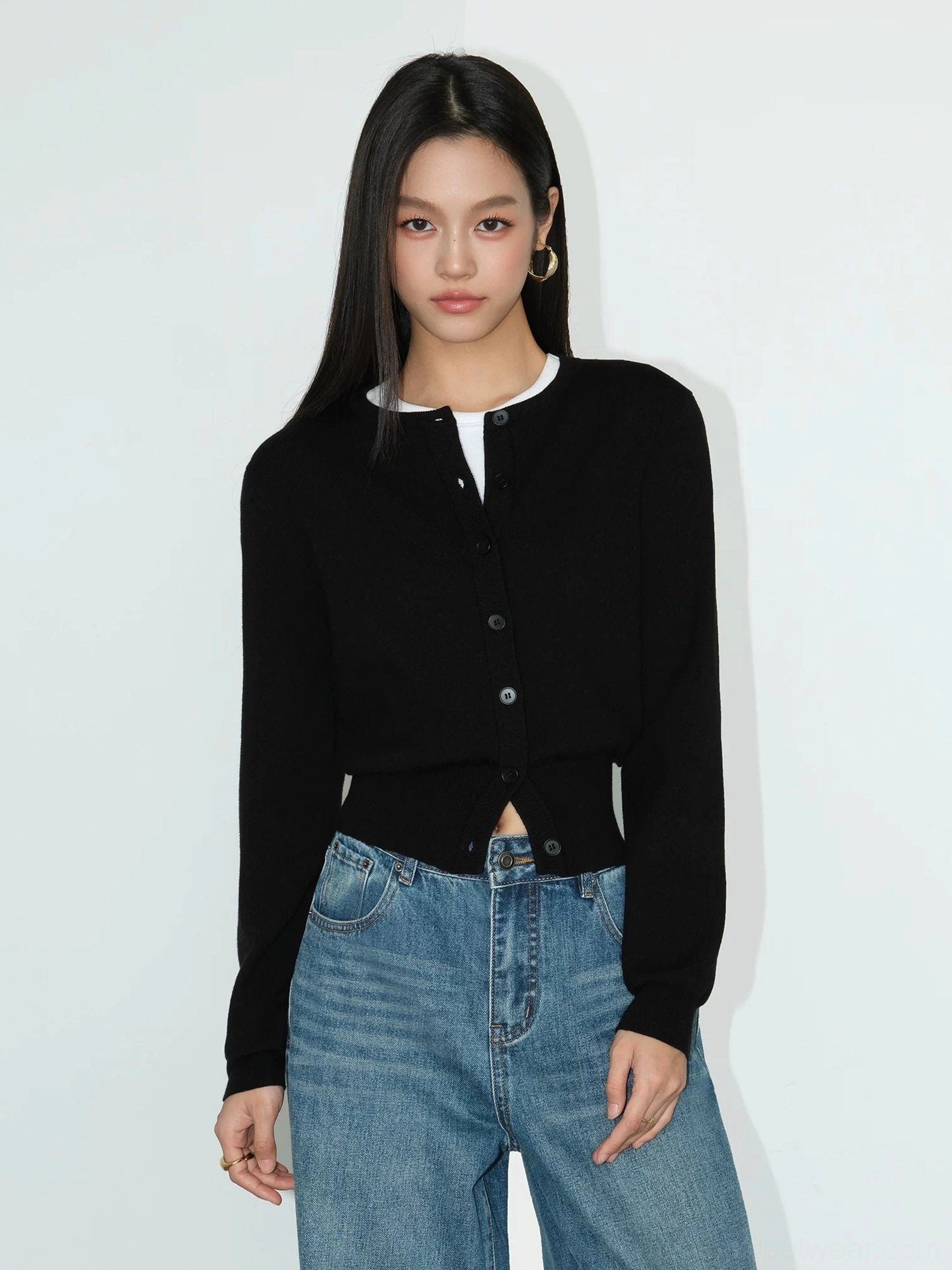 Black women's cropped crew neck button front knit cardigan styled with blue jeans and a white tee