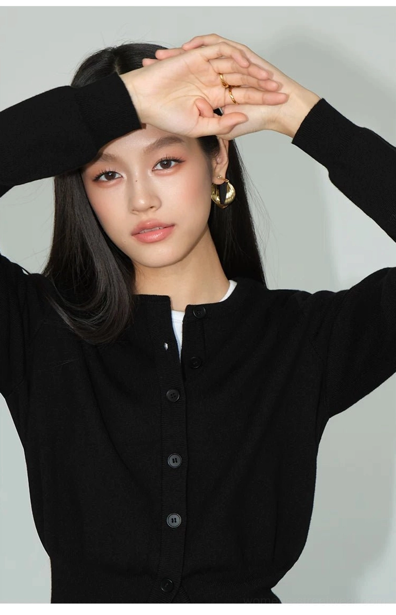 Black cropped crew neck button front knit cardigan close-up showing soft fine-gauge knit texture