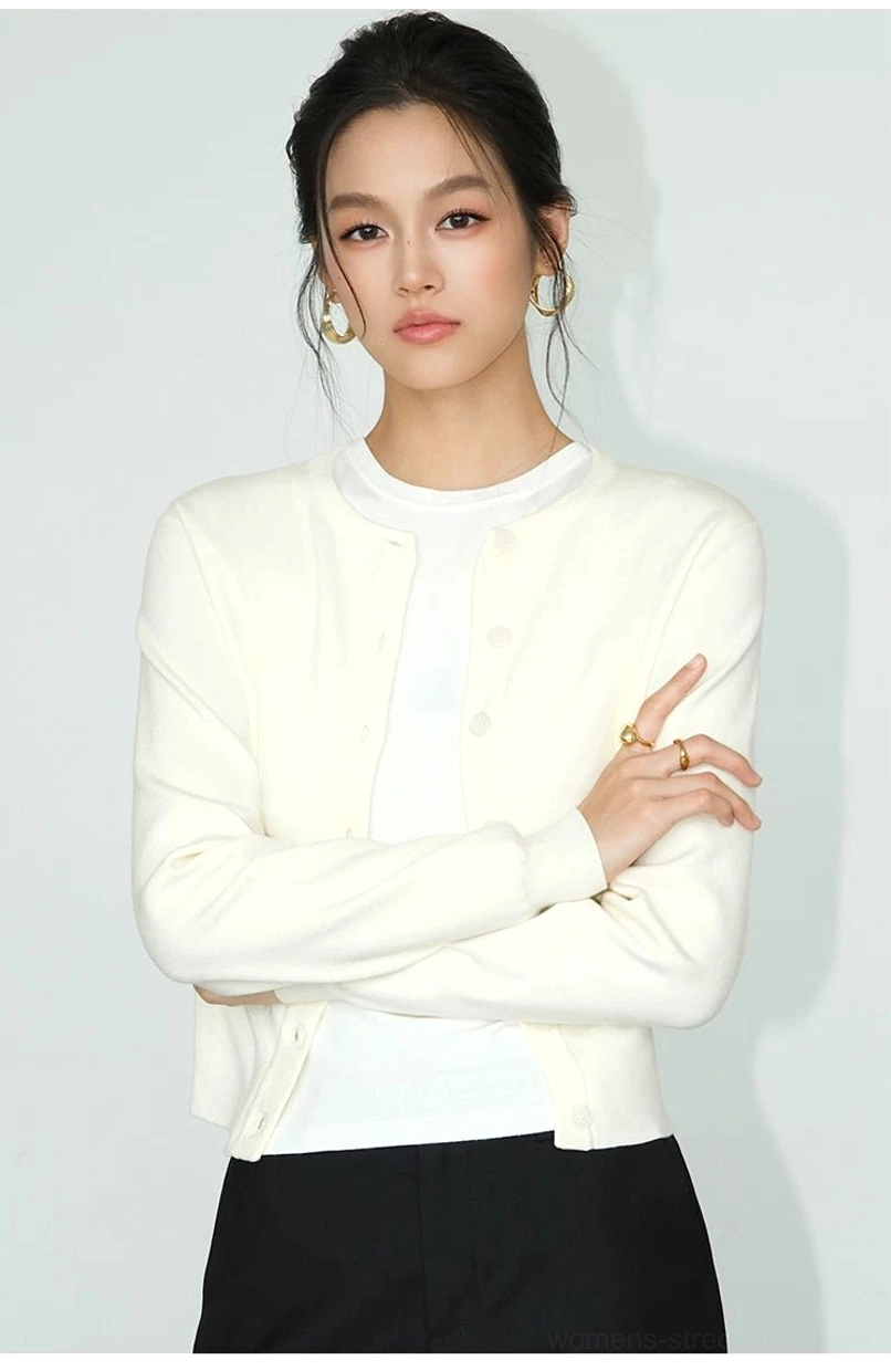 Light apricot cropped crew neck knit cardigan styled with black bottoms in minimalist Korean fashion
