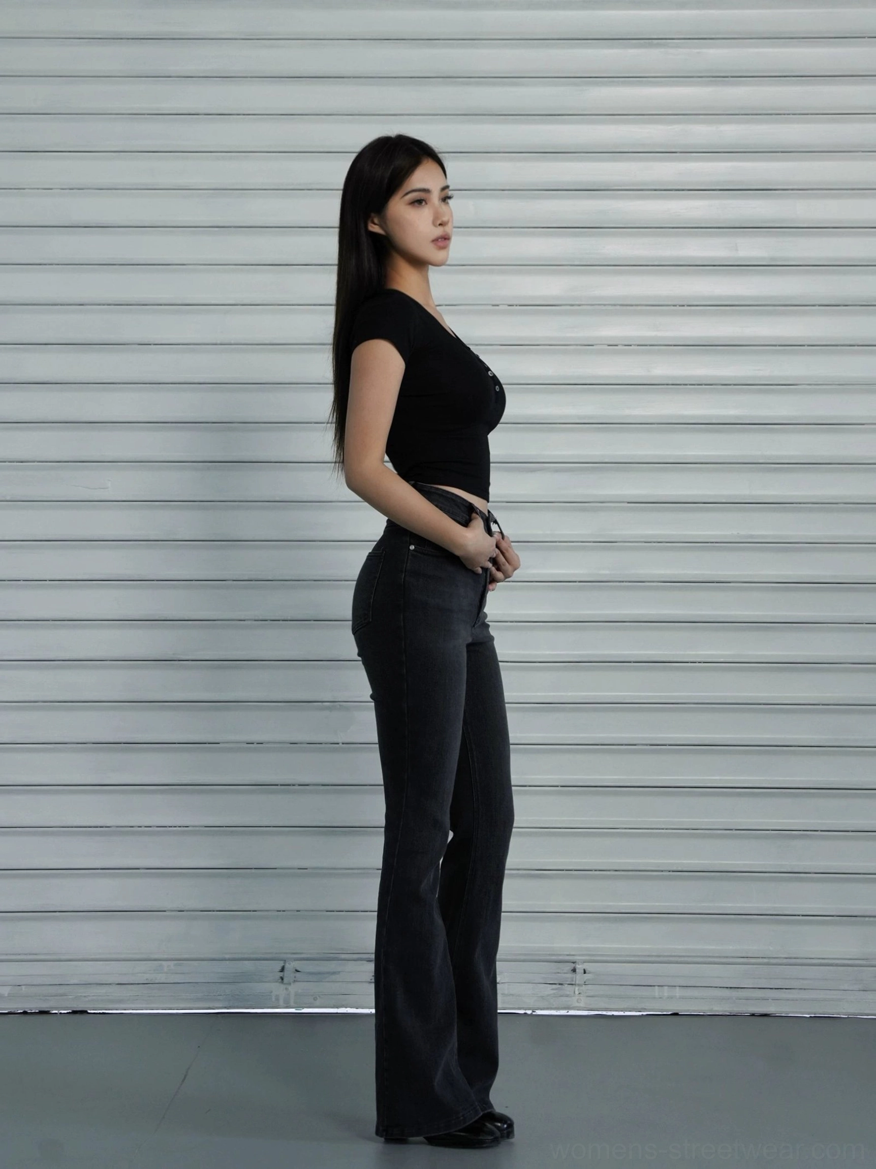 Black cropped Henley baby tee side view showing slim fit silhouette narrow sleeves and short waist length