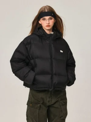 Women's black cropped hooded duck down puffer jacket with stand collar front full view styled with cargo pants