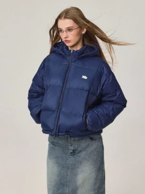 Women's navy blue cropped hooded duck down puffer jacket with stand collar styled with a long denim skirt