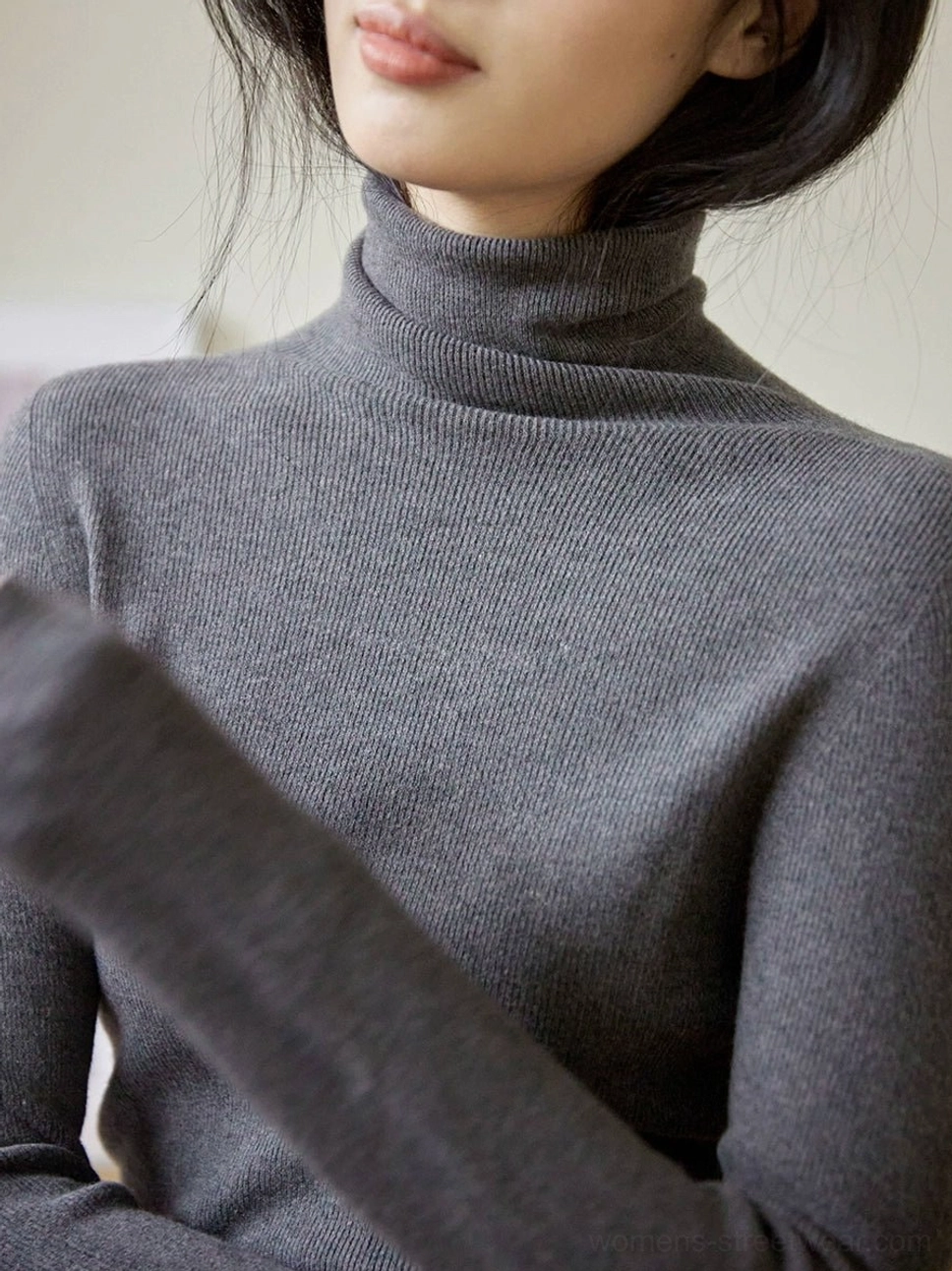 Dark gray ribbed mock neck knit sweater for women shown in a close front upper body view with a slim fitted silhouette