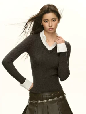 Dark grey layered V-neck ribbed knit sweater with contrast shirt collar and cuffs styled with a brown pleated leather skirt