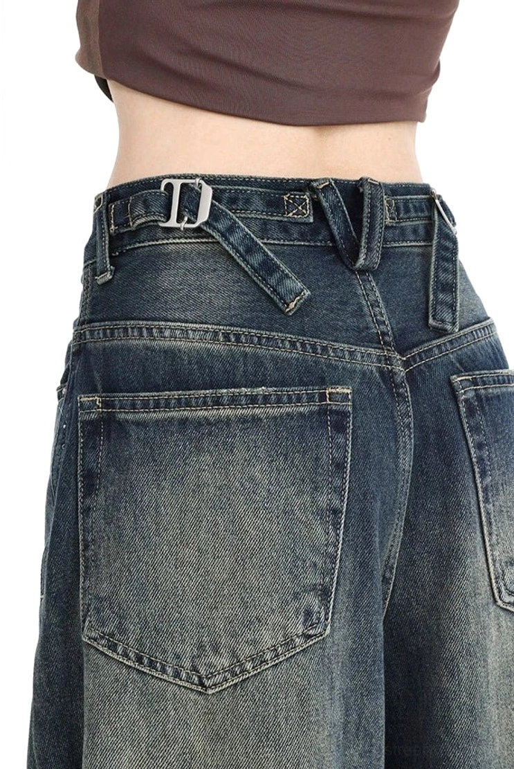 Women's dark wash vintage wide leg ripped jeans with a relaxed high-rise fit, textured distressed knees, gradient denim color, and versatile contemporary streetwear aesthetic