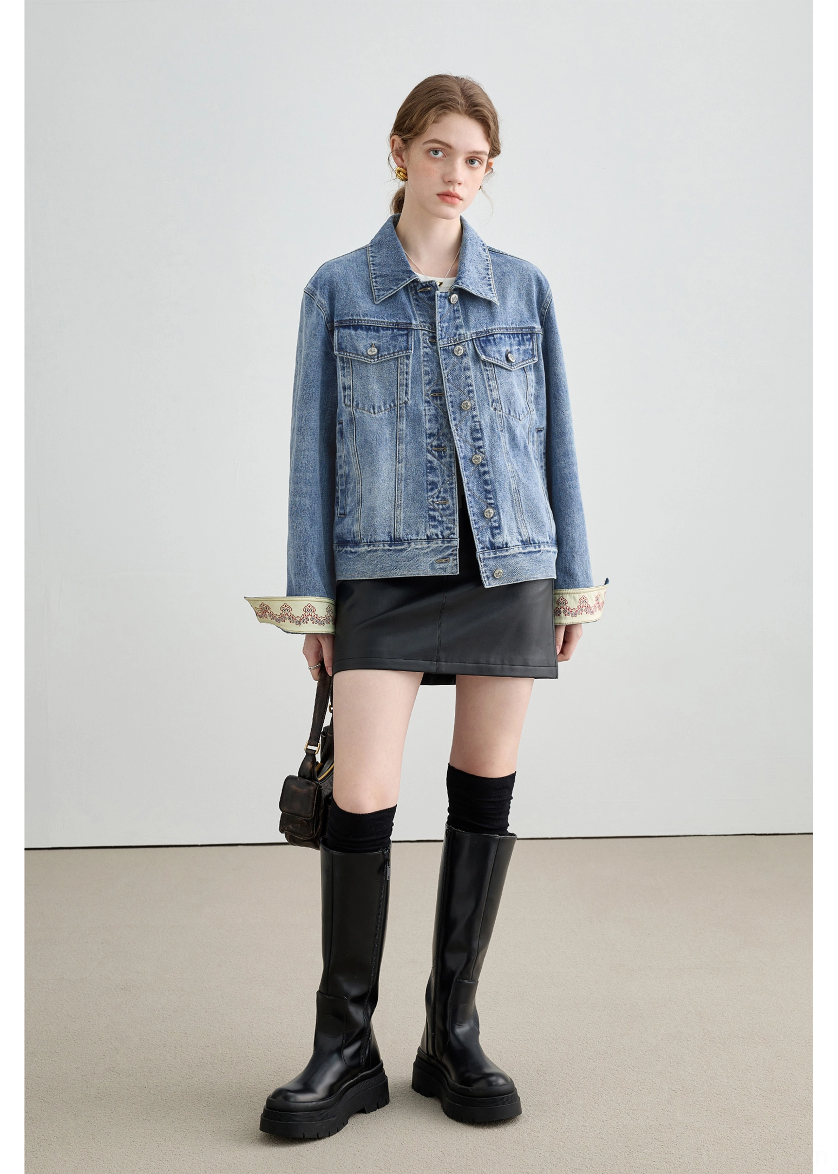 Women’s denim trucker jacket with contrast stitching, button front, chest pockets, and relaxed boxy silhouette