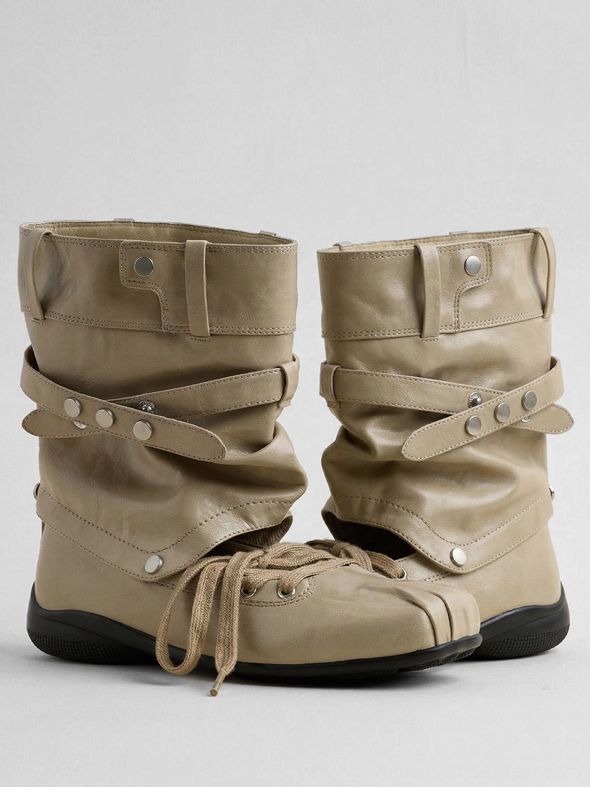 Women's detachable bow cutout square-toe utility boots shown as an edgy Y2K inspired footwear statement