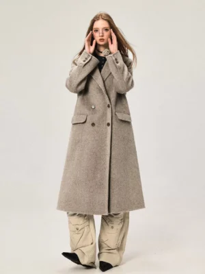 Khaki women's double-breasted Merino wool midi overcoat styled with cargo pants in studio front view