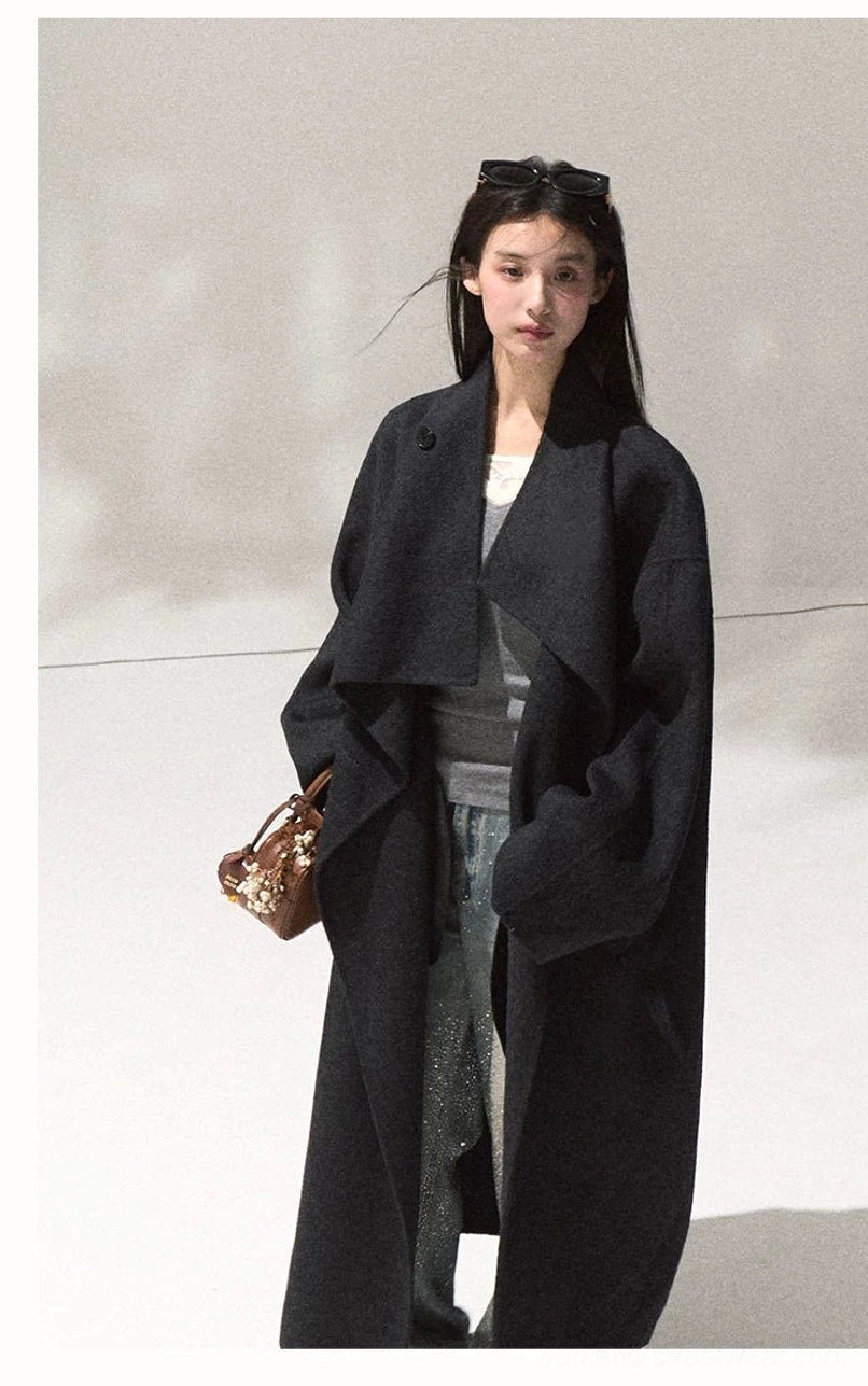 Women's dark navy draped wool overcoat with long relaxed silhouette and minimalist winter layering outfit