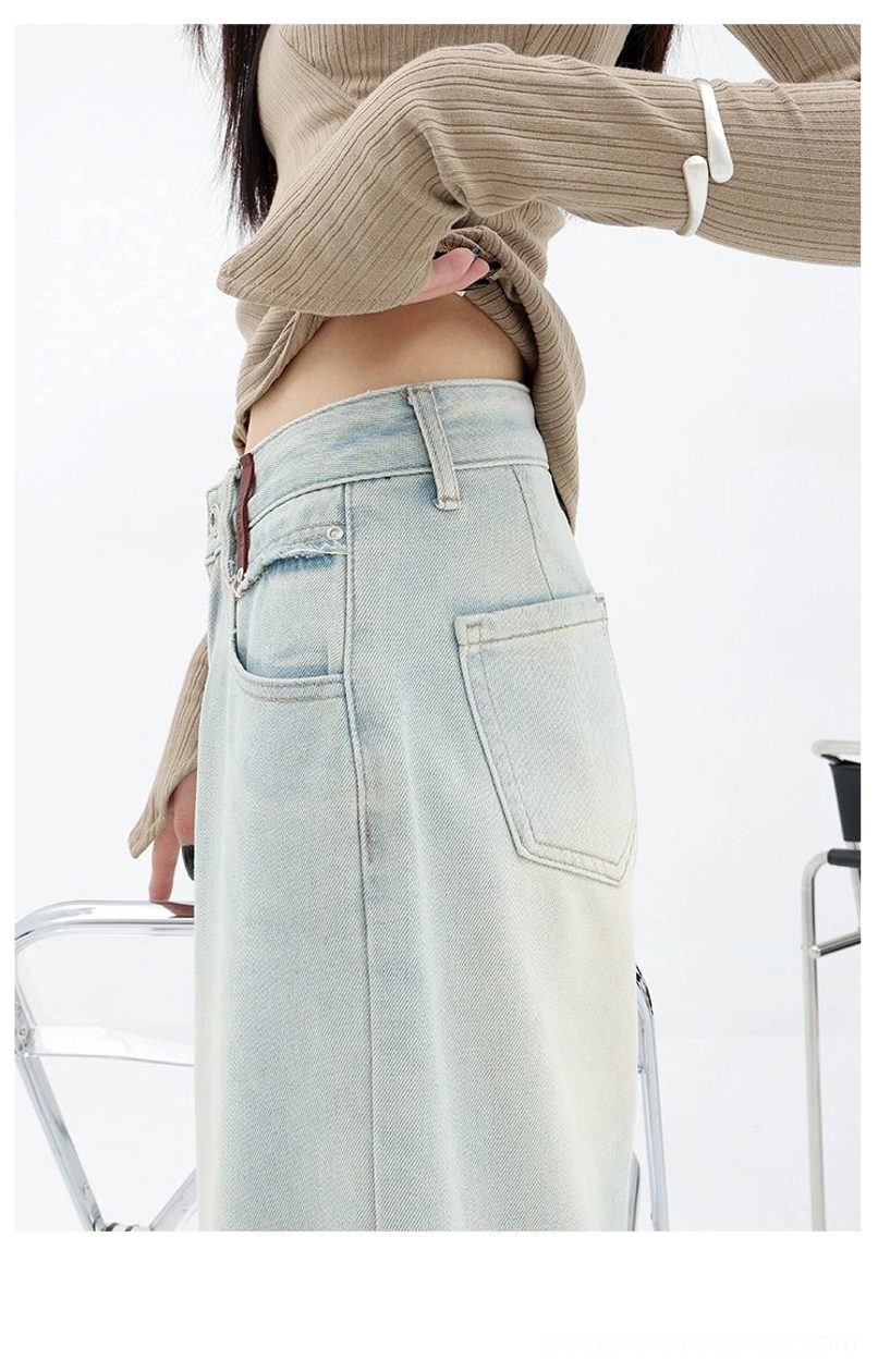 Women’s faded light blue denim trousers with a high waist, loose fit, and distinctive embroidered back pocket