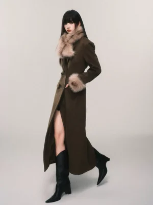 Women's tailored faux fur cuff maxi coat in side profile showing the long wool blend silhouette, shaped waist and rear hem vent