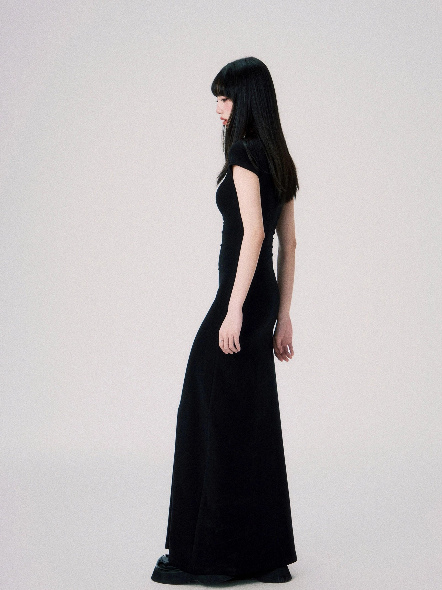 Women’s fitted floor length maxi dress with minimalist butterfly detail and refined evening gown styling