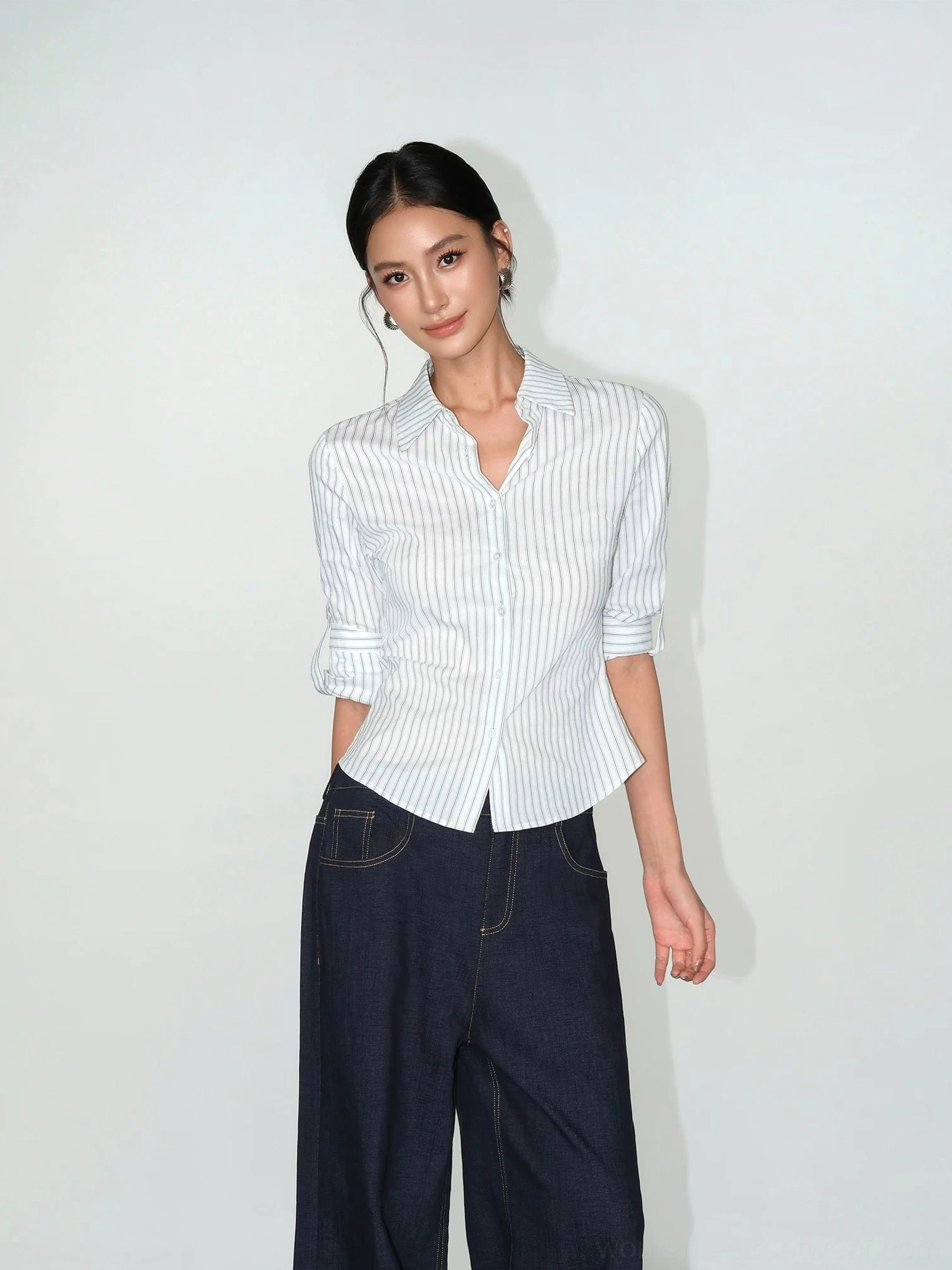 Women's fitted striped work shirt with partially rolled sleeves, classic collar, and dark wide-leg denim streetwear styling