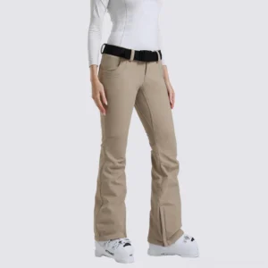Women's khaki flared snow ski pants shown from the front with slim athletic fit, black adjustable belt, hem slits, and ski boots