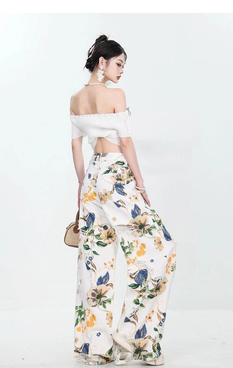 Back view of women's loose wide-leg floral distressed jeans with vintage streetwear styling