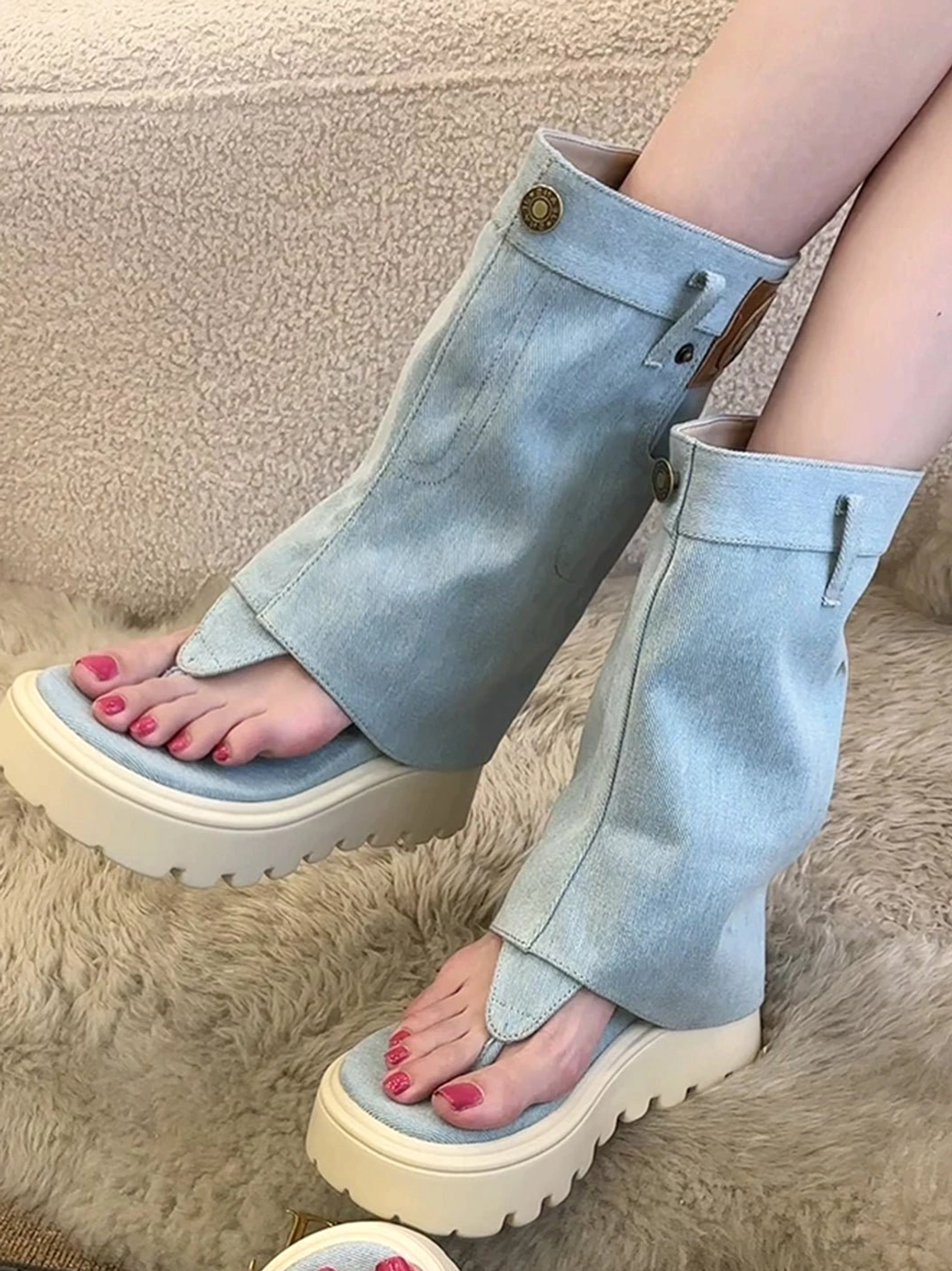 Light blue fold-over platform thong boots worn by model showing cuff pocket and lug outsole