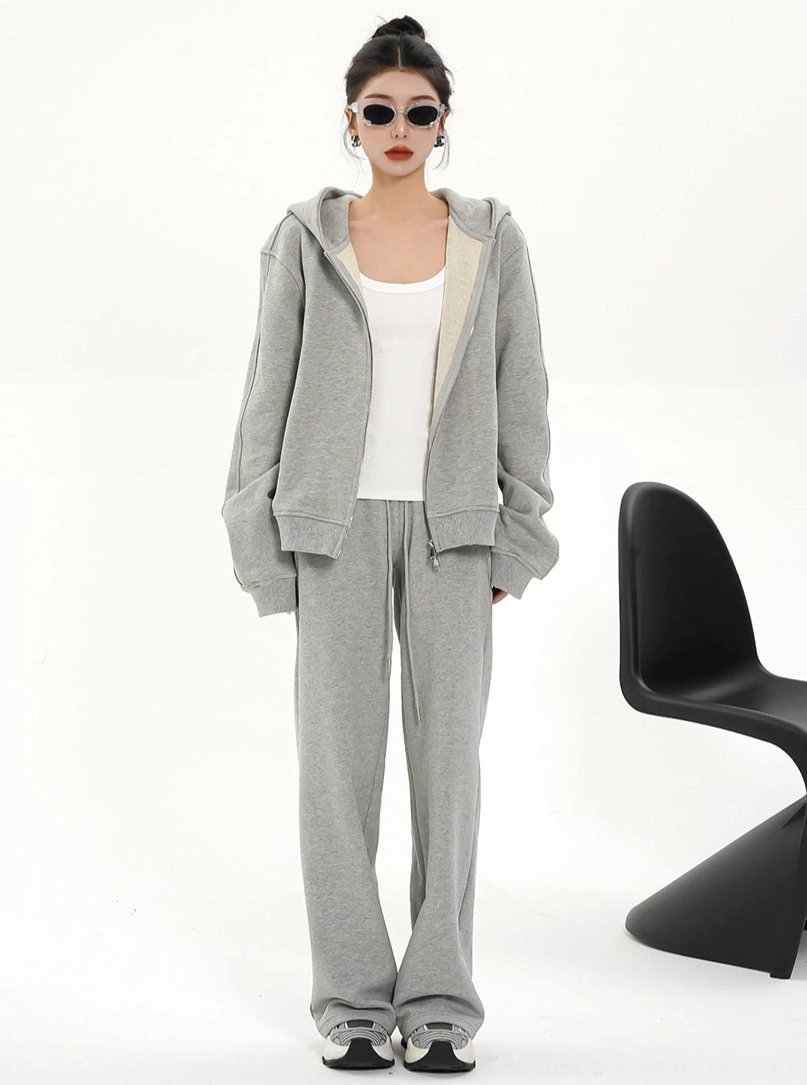 Women's heather gray full zip hoodie jacket shown from the front with a clean minimalist streetwear silhouette