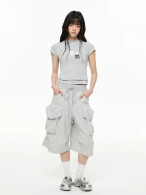 Women wearing heather gray drawstring cargo Bermuda shorts with oversized flap pockets in a Korean streetwear outfit