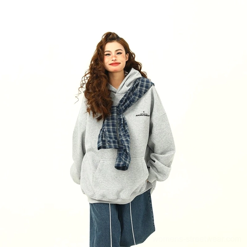 Front view of a women’s heather grey oversized hoodie with blue plaid hood detail, cropped wide-leg jeans, and casual Korean-inspired streetwear styling