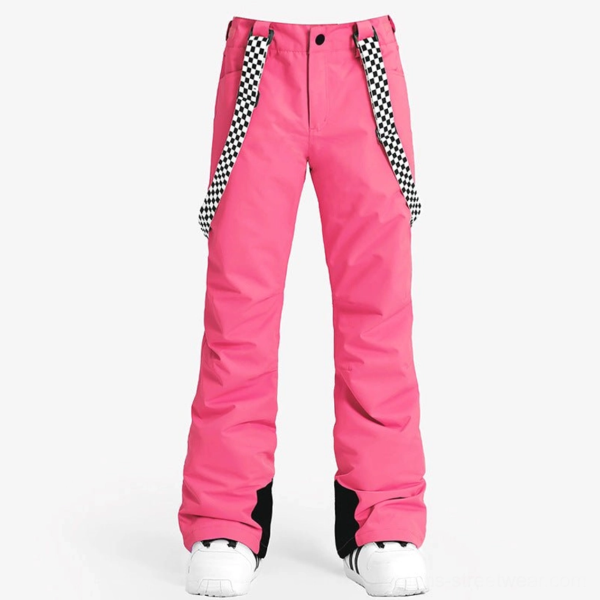 Front studio view of women's hot pink Y2K snow pants with checkerboard suspenders, relaxed flared ski legs, and black ankle accents