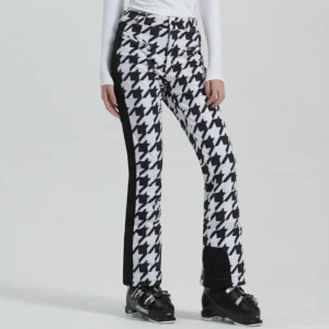 Women’s black and white houndstooth slim flare ski pants with black side stripe and boot cuffs front three quarter view