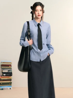 Blue and white striped women's Korean preppy button down shirt styled with a black tie and long dark skirt
