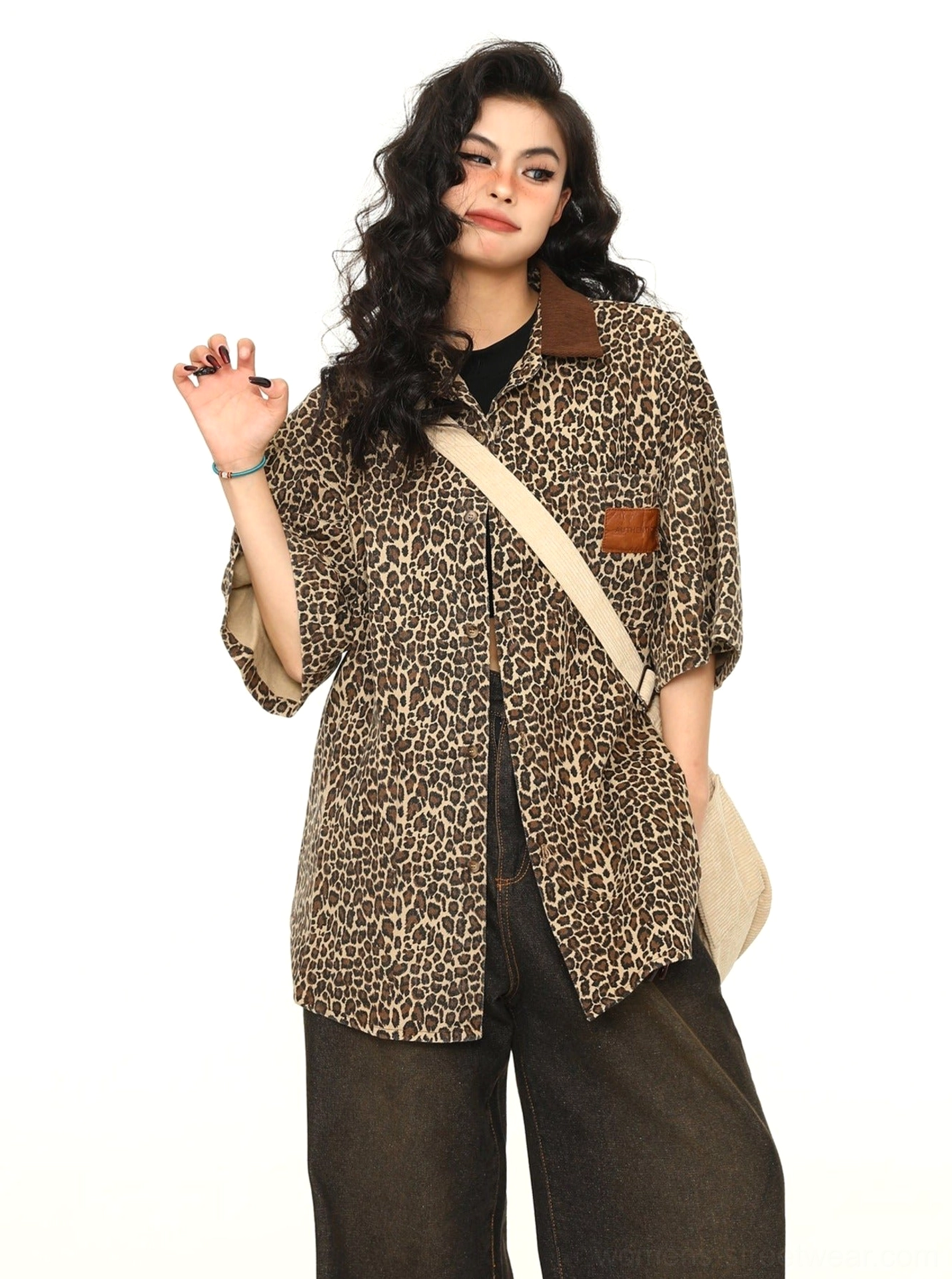Side front view of women's leopard print oversized short-sleeve work shirt showing loose streetwear silhouette and button front