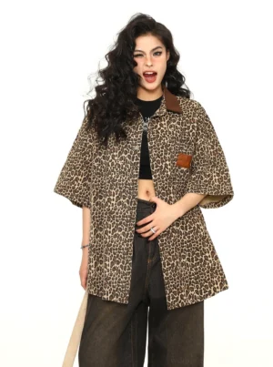 Angled front view of women's oversized leopard print button-up work shirt with brown contrast collar and relaxed short sleeves