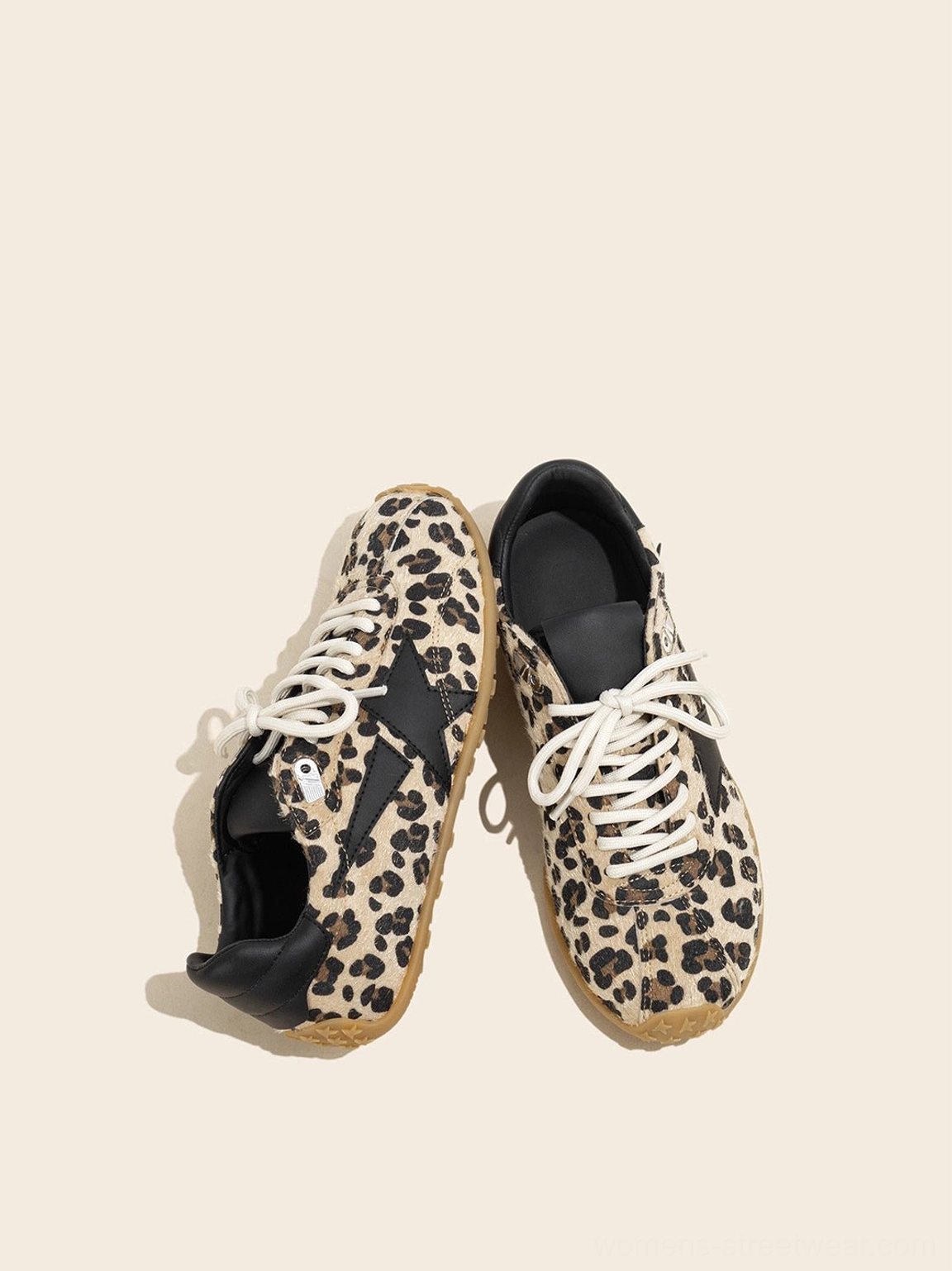 Overhead product view of women's leopard print suede low-profile trainers with contrast cream laces and black heel panels