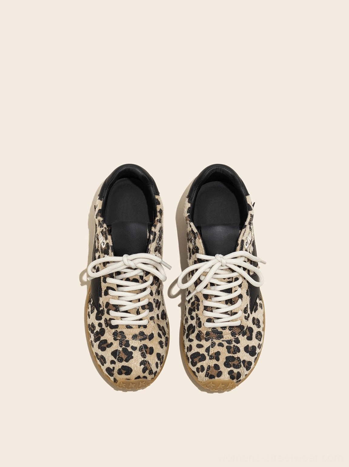 Front view of pair of women's leopard suede low-profile trainers with cream laces rounded toes and gum outsoles