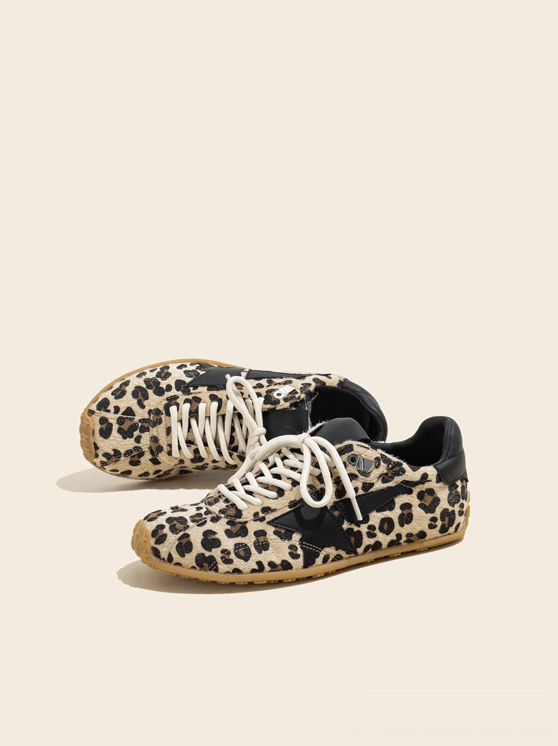 Low angle view of women's leopard suede star low-profile retro trainers showing vintage sneaker silhouette and gum outsole