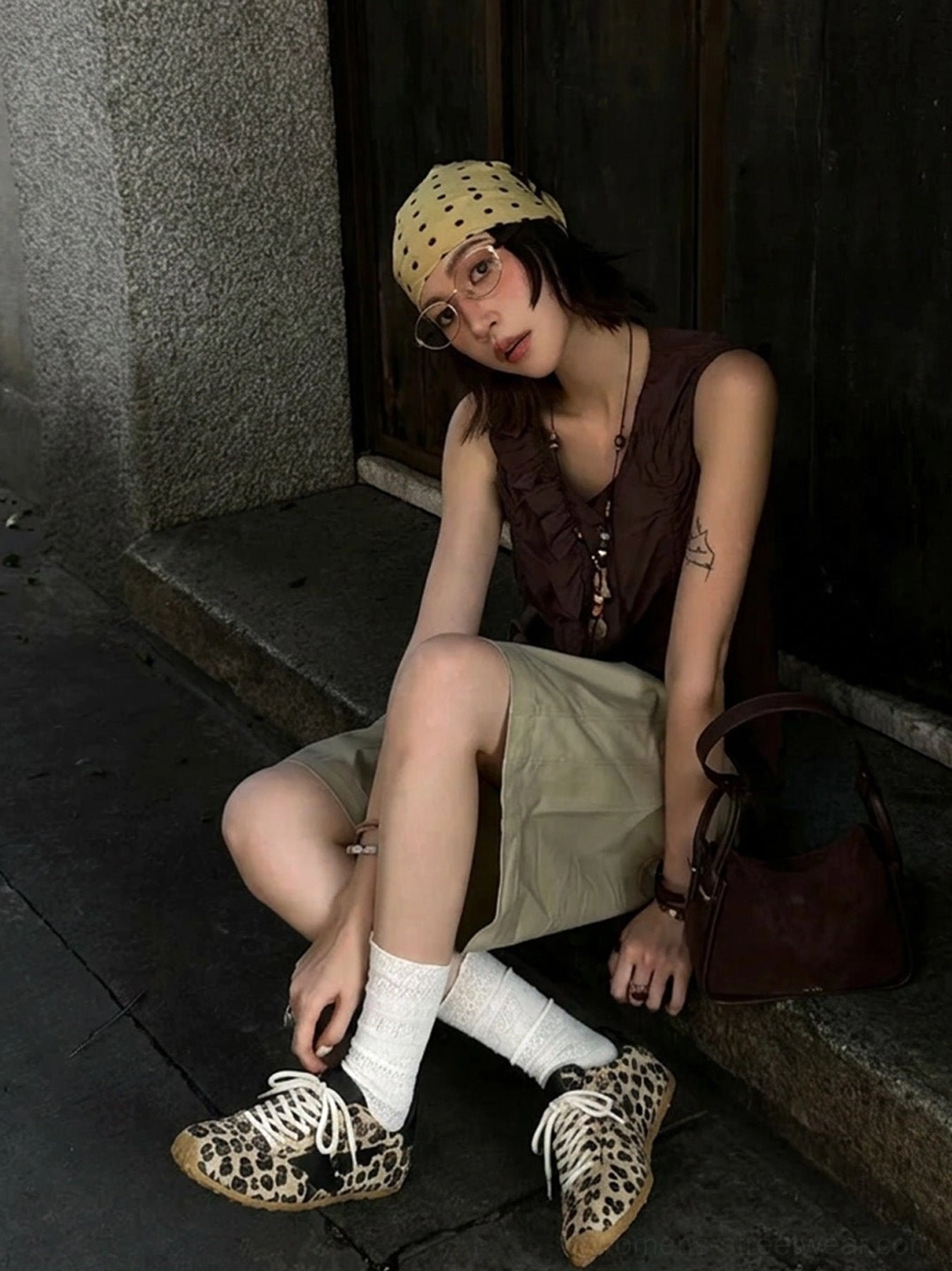 Women's leopard suede star retro trainers styled with a neutral streetwear outfit on outdoor stone steps