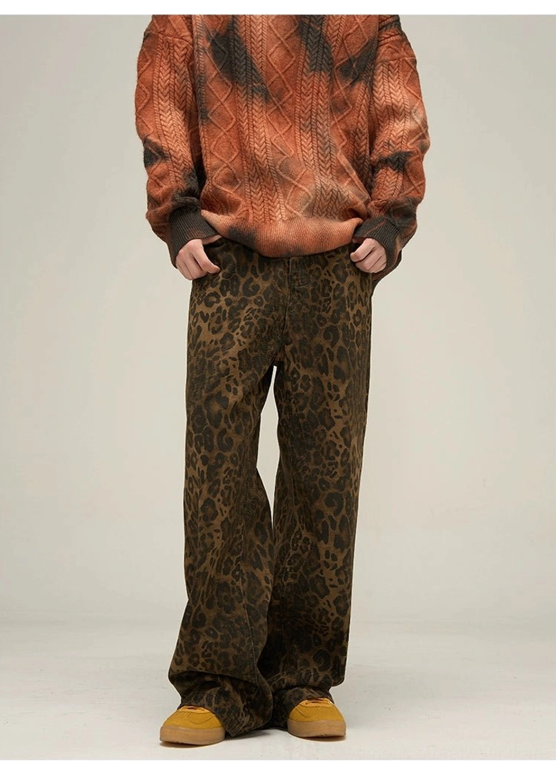 Front view of women's leopard print wide leg pants styled with an orange-brown tie-dye knit sweater and casual shoes
