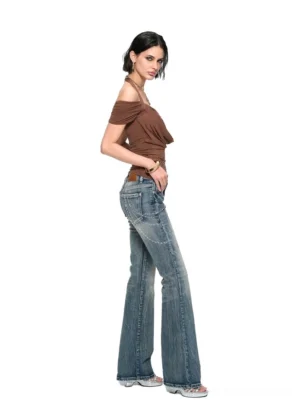 Side view of women's light blue rhinestone bootcut jeans showing the vintage washed denim finish and subtle flared leg