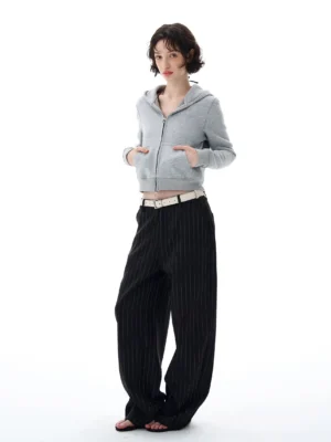 Women's light heather gray cropped zip-up hoodie front view styled with pinstripe wide-leg pants