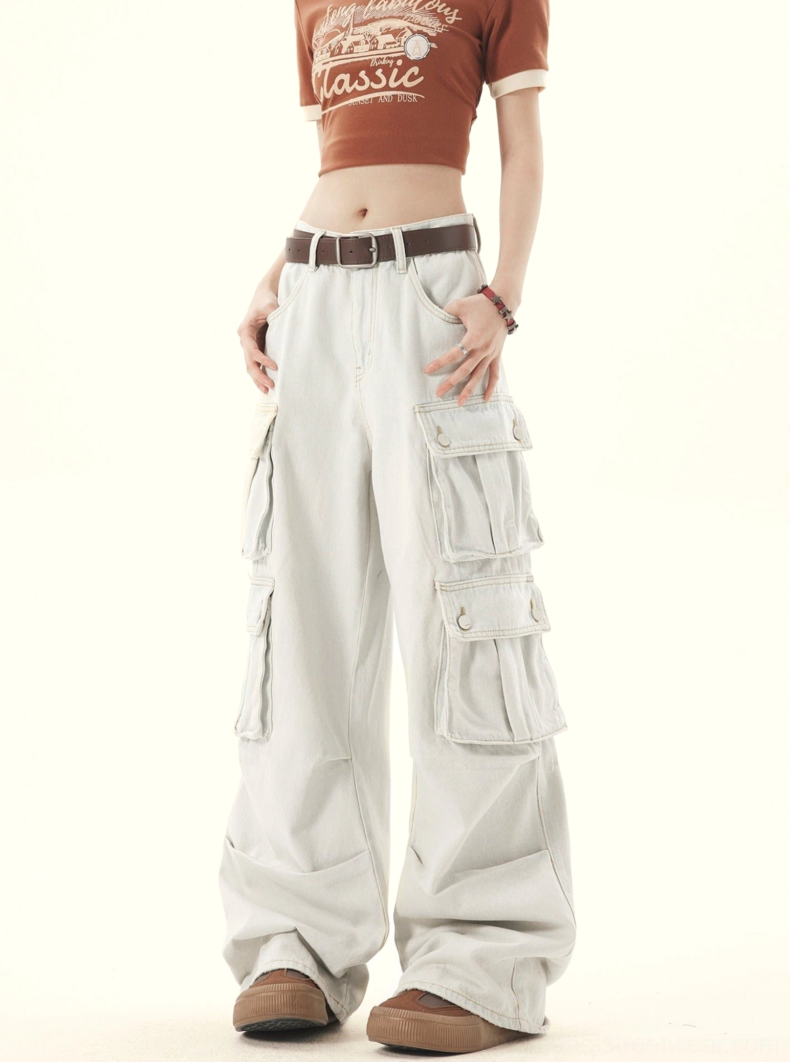 Left front side view of women’s relaxed fit light wash denim cargo jeans with full length wide legs