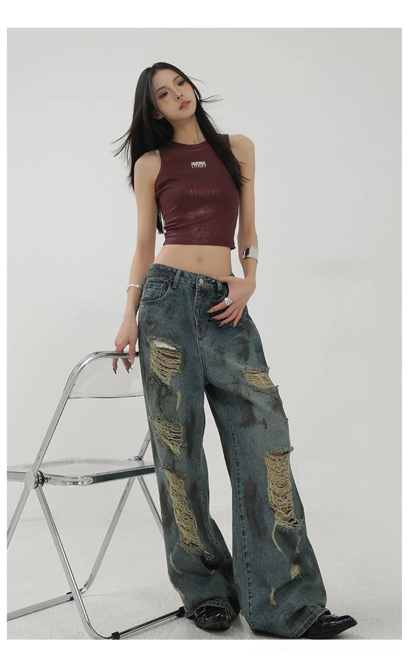 Women's loose distressed wide-leg denim jeans with tie-dye-inspired fading and an edgy vintage finish