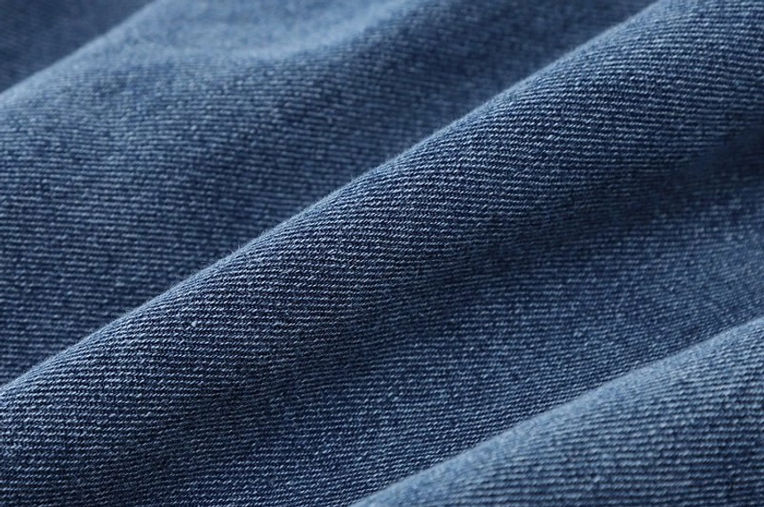 Women's loose fit denim shirt jacket in washed blue with practical layering versatility for autumn and winter outfits