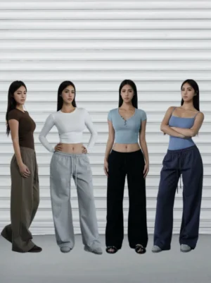 Women’s drawstring wide-leg streetwear pants shown in multiple colorways with cropped top styling in a studio group photo