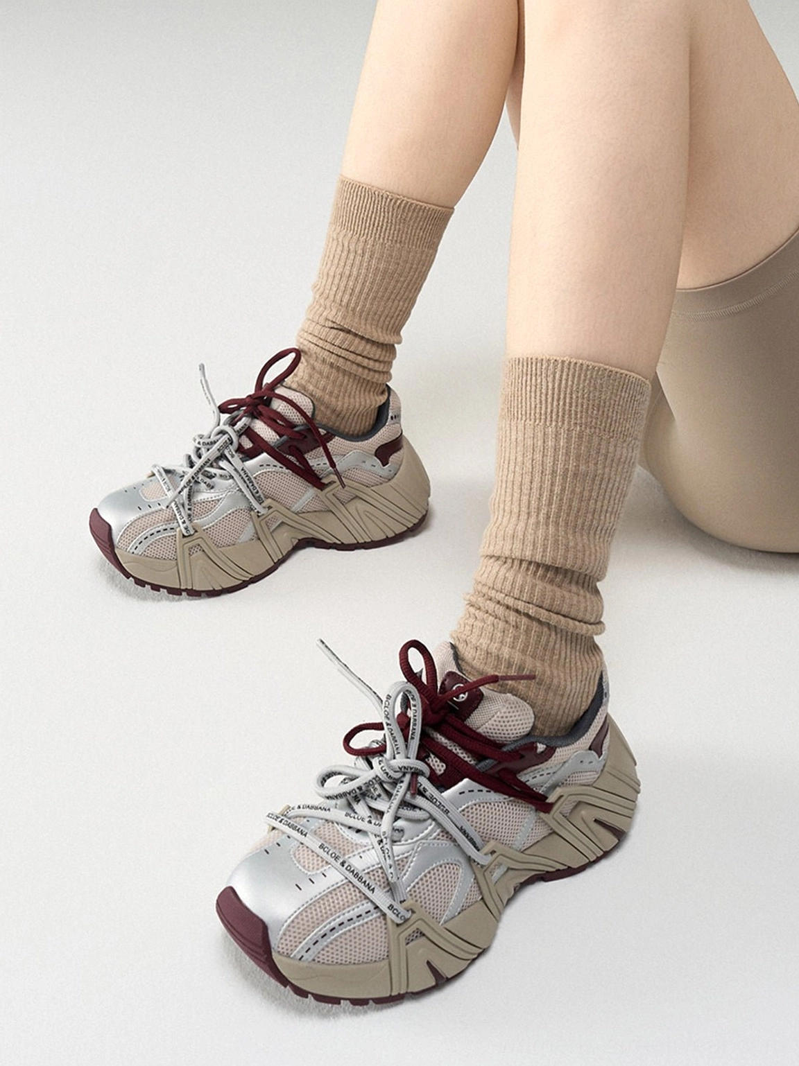 Top view of women's beige mesh cage runner sneakers showing rope laces metallic cage overlays and ventilated multi-panel upper