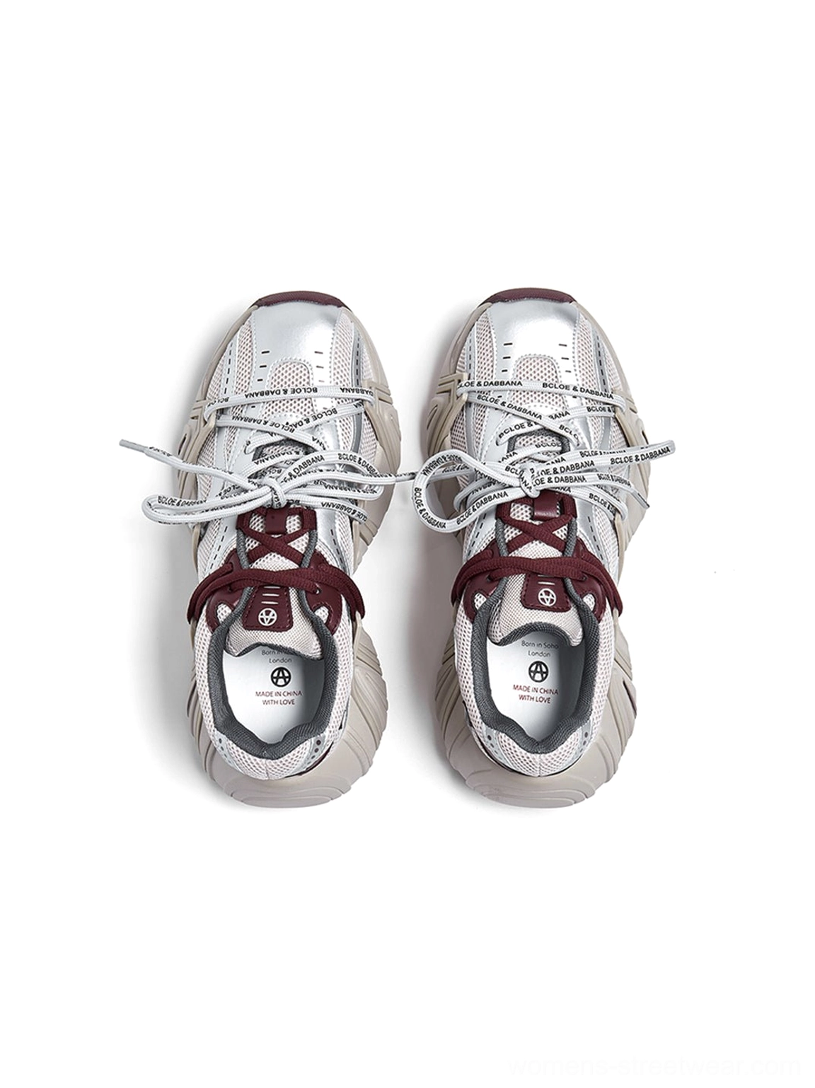 Outsole view of women's mesh cage runner sneakers showing rugged segmented tread pattern and branded insoles