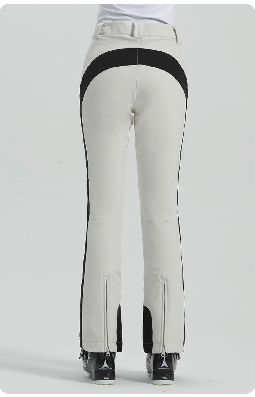 Off-white women's slim flared ski pants with black side stripe, clean bootcut leg, and contemporary alpine streetwear design