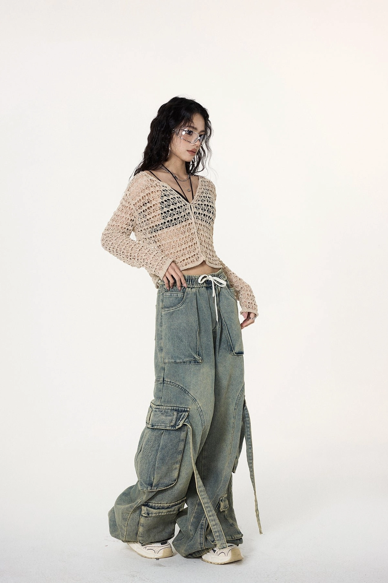 Women's open-knit khaki crochet cardigan with a sheer texture, cropped silhouette, and long sleeves